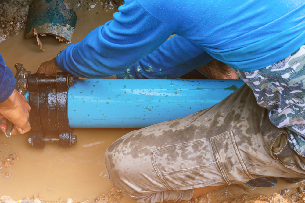 blue water line being installed by worker